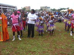 Community celebration with people gathered in colorful dress